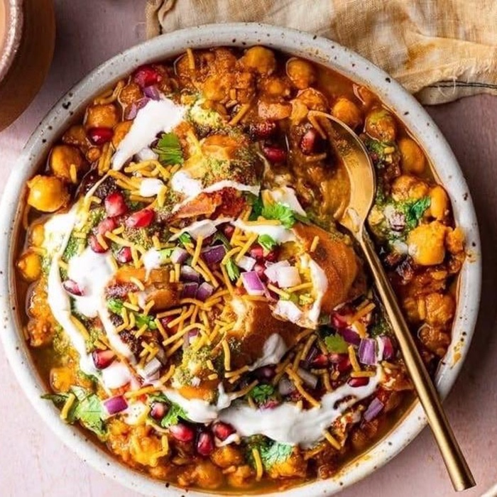 Aloo tikki chaat with chickpeas, yogurt, pomegranate and sev